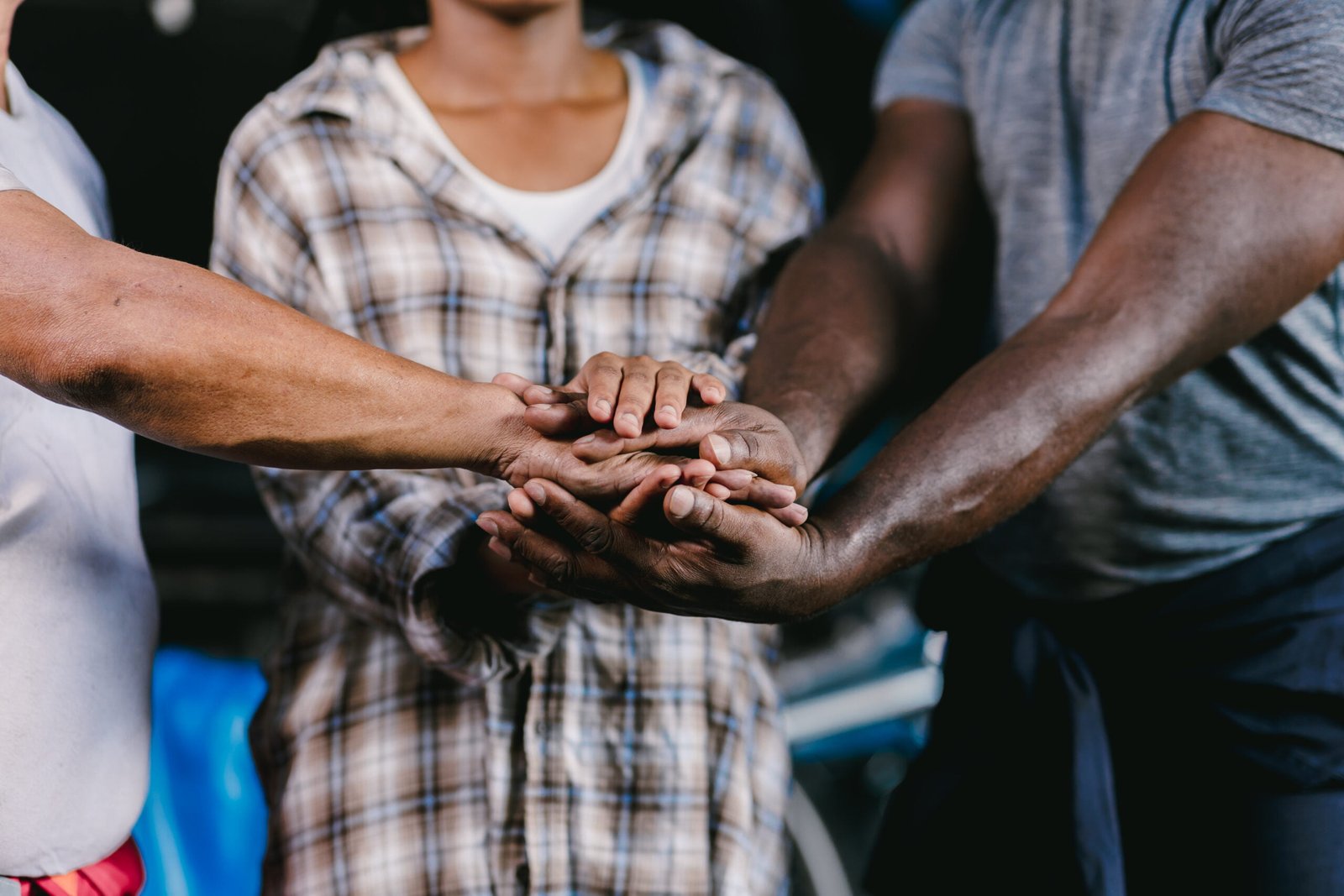 closeup-of-diverse-people-workers-joining-their-hands